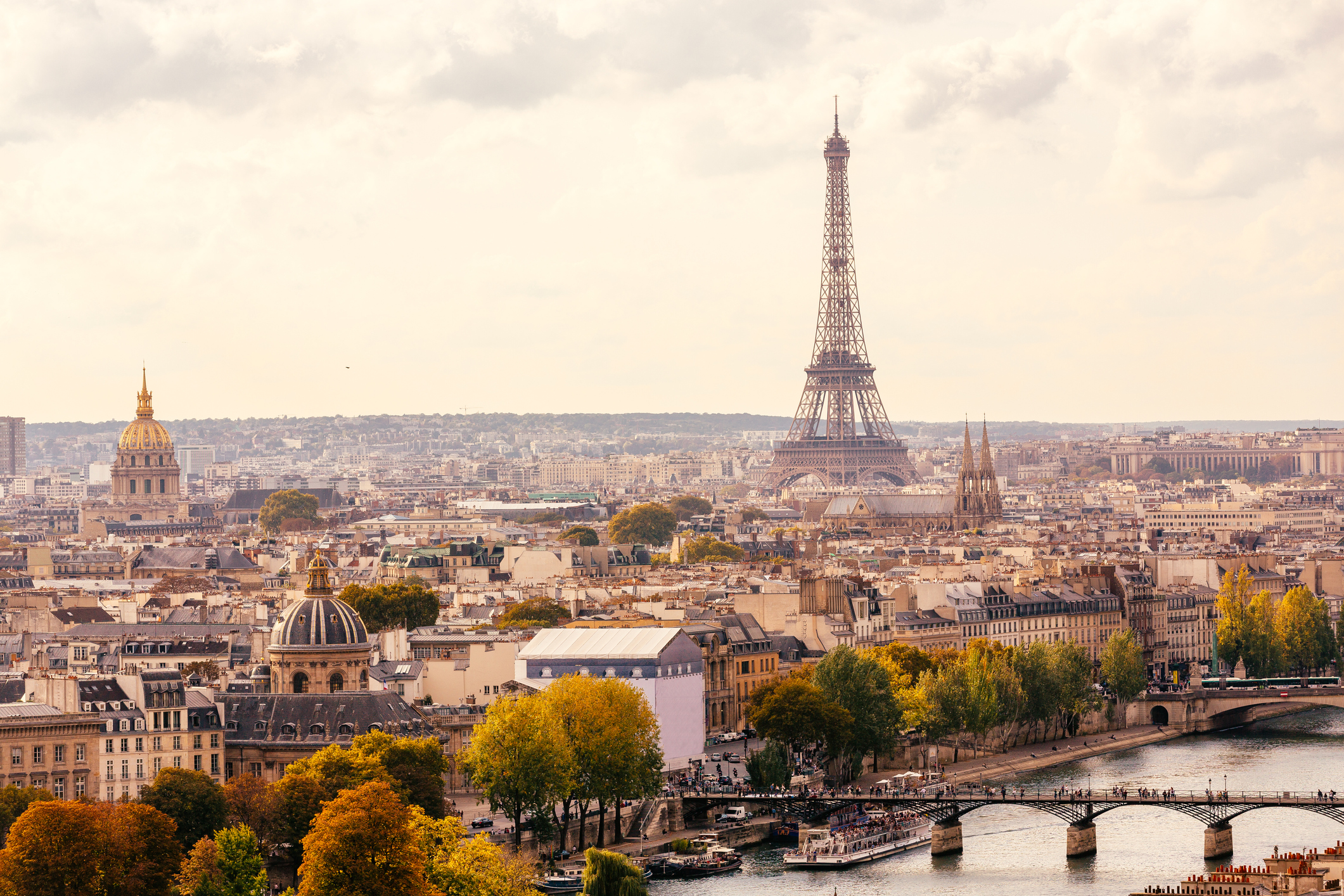 Paris skyline with Eiffel Tower and Pont des Arts bridge at sunset, France