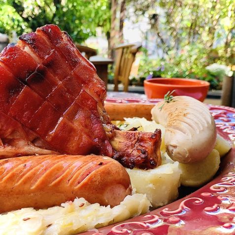 Schlachteplatte “Chucrute a Garni" com Eisbein (joelho suíno salmourado e cozido), Kasseler (bisteca), salsichas Schüblig, Debreziner e Kalbswurst, guarnecido com chucrute e batatas cozidas do Gansaral / Divulgação/