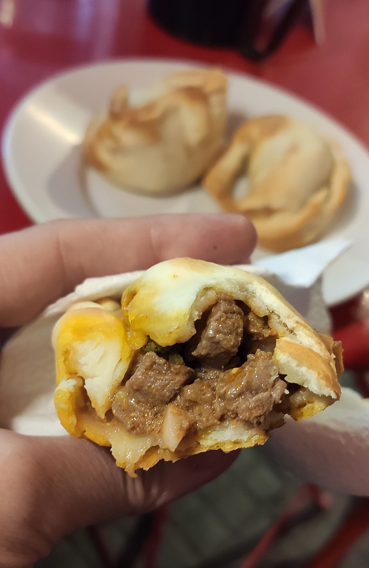 Empanada de Tucumana da La Campeona leva pedaços de carne cortados na ponta da faca / Giuliana Nogueira