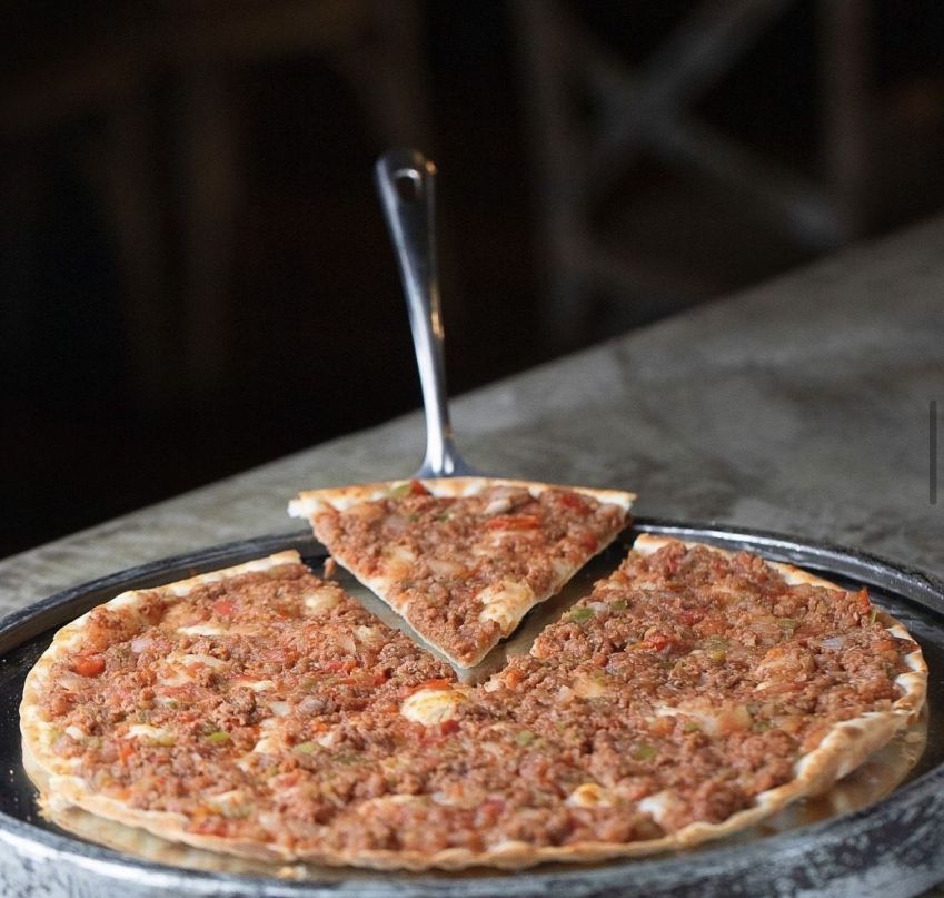 As esfihas abertas no restaurante Zaytun levam o nome de Manakeesh e tem o tamanho e formato de uma pizza brotinho. Na foto, a de carne • Reprodução Instagram Zaytun