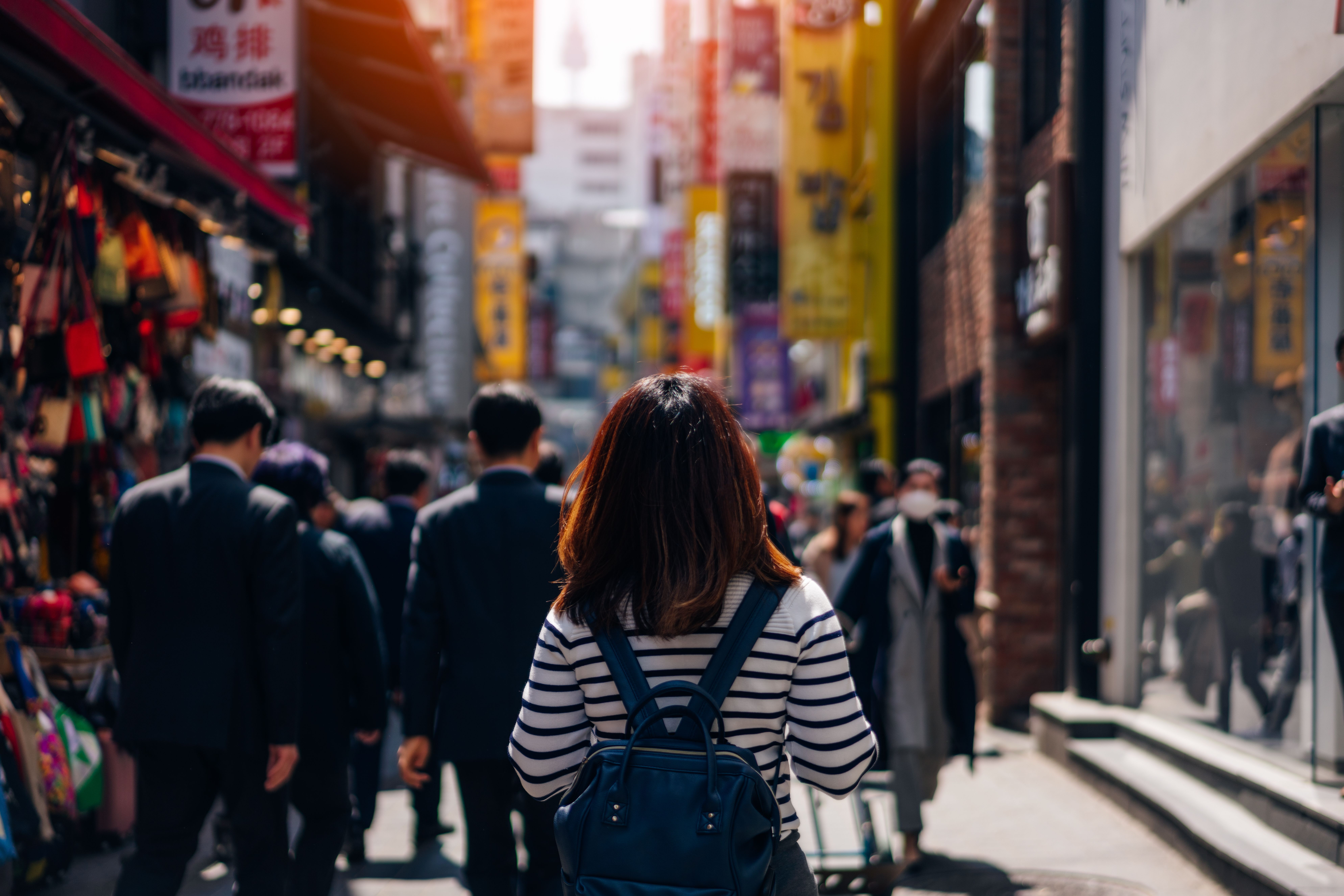 Young asian woman traveler traveling and shopping in Myeongdong street market at Seoul, South Korea. Myeong Dong district is the most popular shopping market at Seoul city.